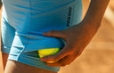 Girl wearing a Roggio blue tennis short leggings showing the pocket detail