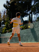 Junior tennis player on a clay tennis court wearing Roggio outfit