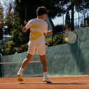 Boy playing tennis on a clay court with Roggio outfit